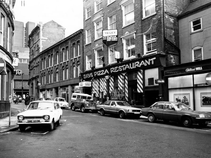 Mill Hill taken from Bishopgate Street in December 1979. On the Right is William Hill bookmakers then Bibi's Pizza Restaurant. Further along is an amusement arcade. In the background is Bond Street. Just visible on the left is the Black Lion pub.