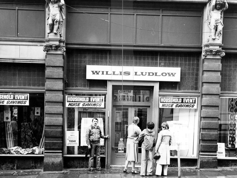 Willis Ludlow department store on the Ludgate Hill side of Kirkgate Market. Shoppers are looking in the windows which advertise 'Huge Savings'. Pictured in January 1979.