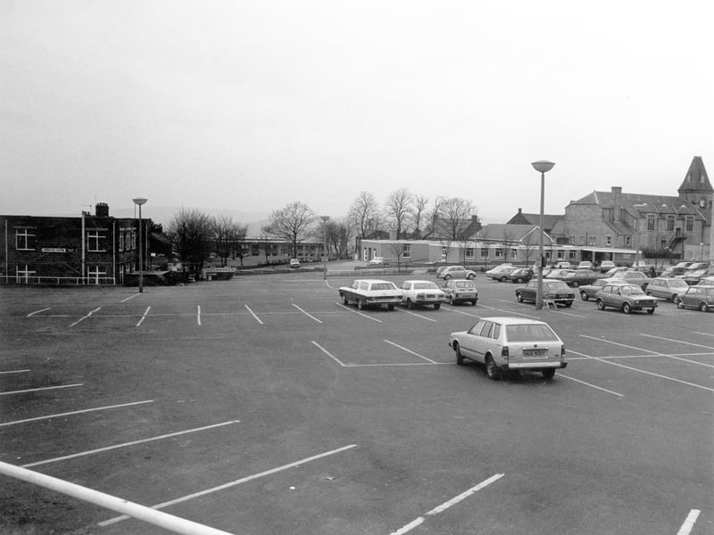 Morrisons car park looking towards South View Road where the long, single storey building of Yeadon Health Centre can be seen. On the left is the Trades Hall Social Club, now demolished to make way for Morrisons petrol station. Pictured in  December 1979.