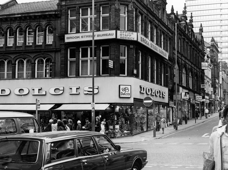 Looking up from King Edward Street to Briggate and the junction with Albion Place in April 1979. Dolcis shoe shop is on the corner of Briggate and Albion PLace and above, at number 17 Albion Place, is Brook Street Bureau, office staff agency. West Riding House is visible in the background
