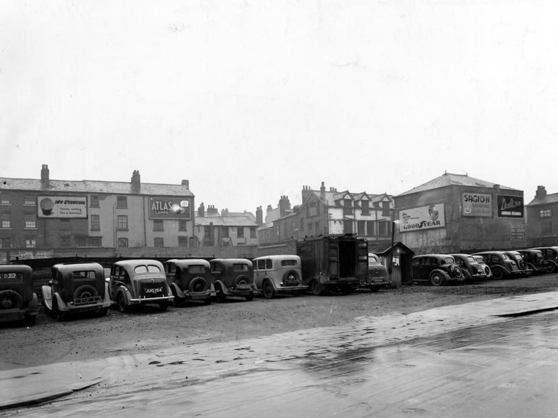 A view of car park on Merrion Street in April 1947. Billboards in the background for Guinness, Atlas Lamps, Goodyear Tyres, Sagion Stuffing and Dalton's Cereal Flakes.