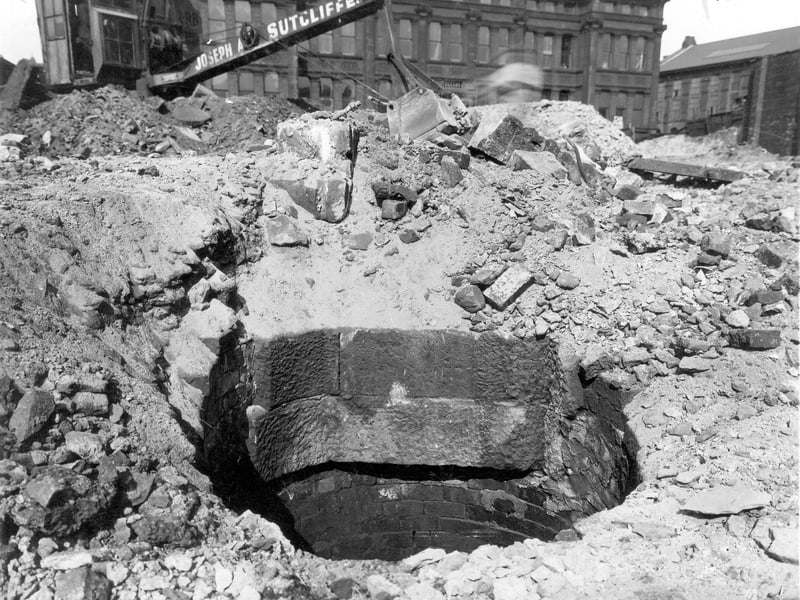 Close up view of excavation revealing an old well. In the background can be seen City of Leeds School. Pictured in June 1941.
