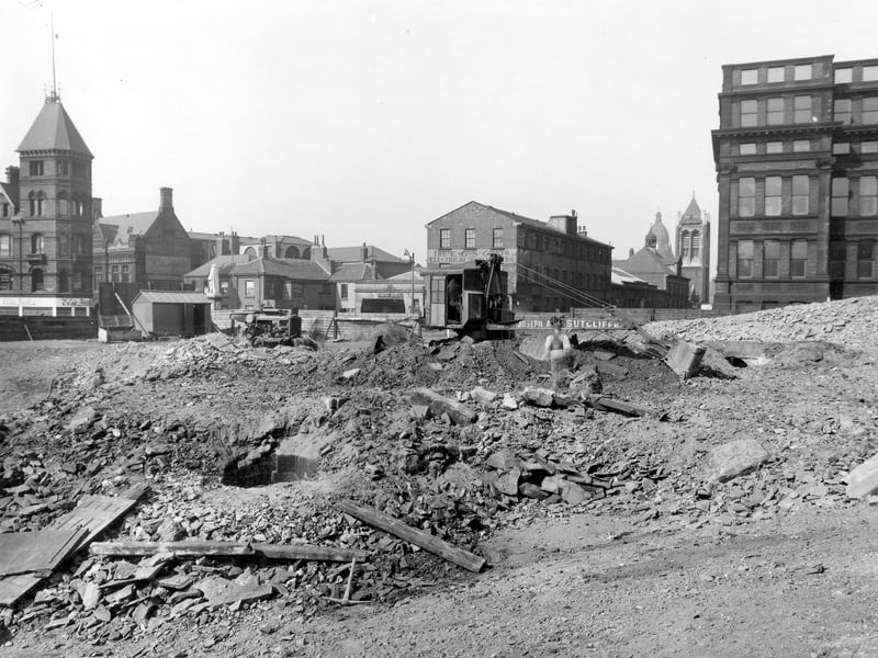 Excavation of land for static water basin. An old well has been revealed. In the background can be seen City of Leeds School, on the right the tower of St Anne's Cathederal, the Town Hall dome, and business premises along Woodhouse Lane. The statue of H R Marsden can be seen to the left of the photo from June 1941.