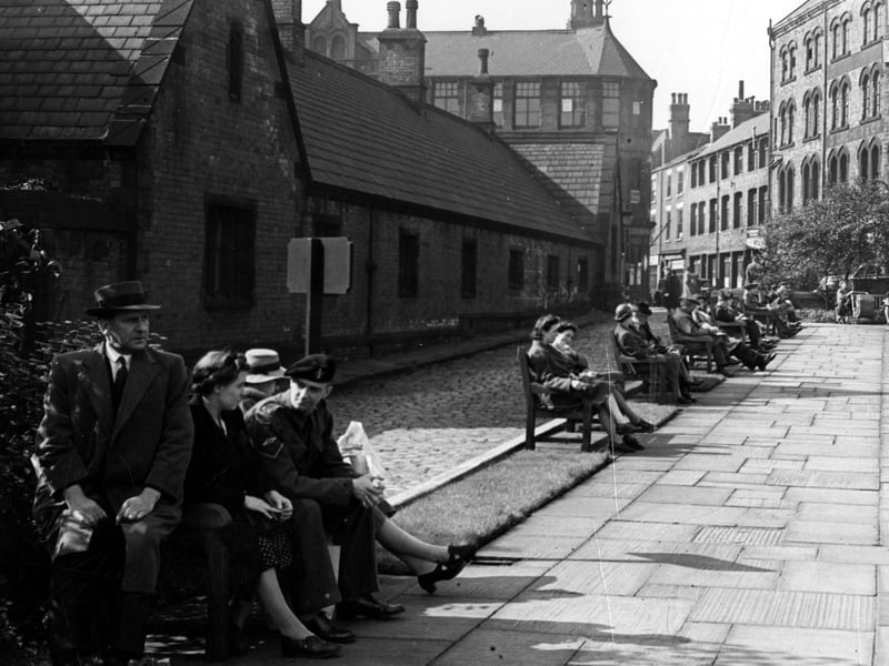 Looking south at the rest garden on Merrion Street in September 1943. People sit on park benches in the foreground.