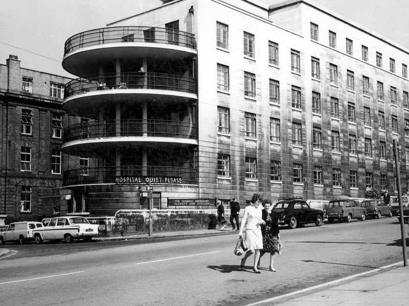 The Brotherton Wing at Leeds General Infirmary taken from Calverley Street. The Brotherton Wing was built and opened in 1940. A large sign says Hospital Quiet Please. Second sign reads the General Infirmary patients and visitors. People are sat on the balconies.