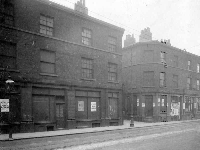 Meadow Lane in May 1900.  Three storey buildings, lower level shop fronts. From left, number 23 had been occupied by Wm. Addy, Ale and Porter Stores. Number 25/27 Wm. Rusby picture framer. Next came Josiah Ramskill, Surgeon, then on right number 33 South Market Hotel.