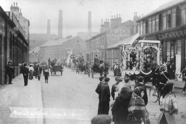 Hunslet Carnival looking north along Hunslet Road. People are on the roads and pavements watching a procession of horse and carts go past. Pictured in June 1906.