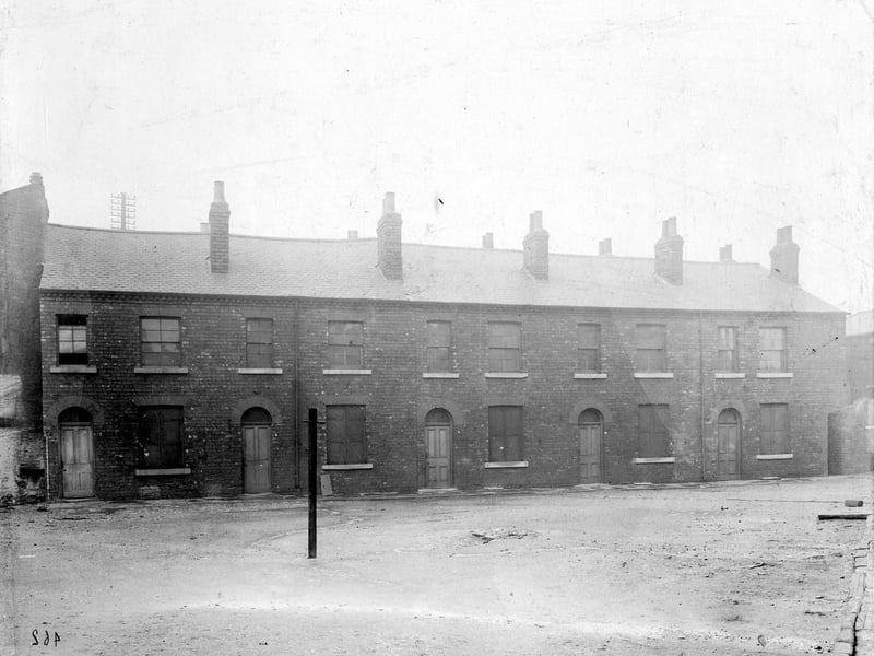Ivory Street pictured in December 1901. Cross Myrtle Street, area for improvement. Row of two storey brick houses, with cleared ground in front.
