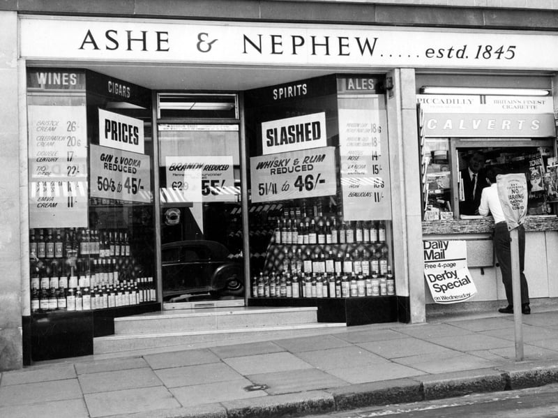 Ashe and Nephew, wine merchants on Albion Street. A man appears to be buying something at Tobacco Kiosk next door.