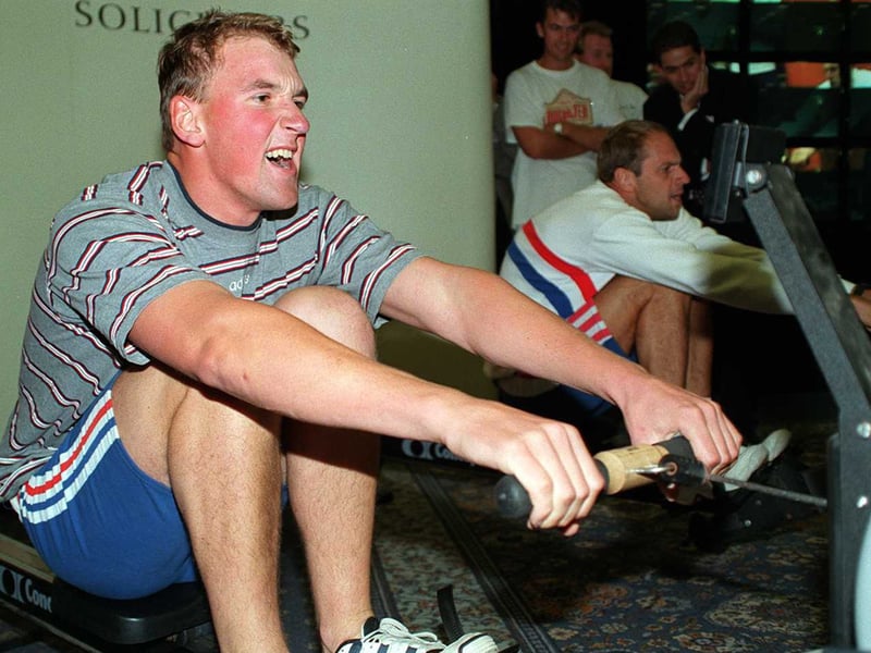 Matthew Pinsent and Steve Redgrave race each other on rowing machines at Headingley Cricket Club.