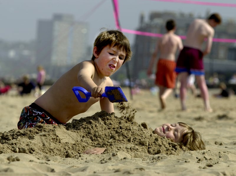 Katie Mellish from Newington buries her brother Conor in the sand on Portobello Beach in August 2002.