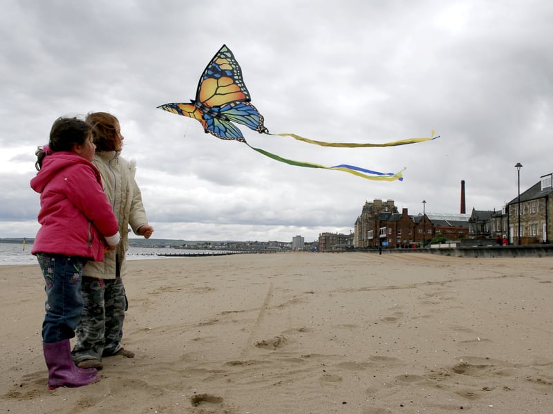 Charlotte Gemmell and her sister Ellie Gemmell, from Glasgow, enjoy the windy weather on Portobello Beach in May 2007.