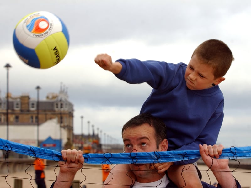 Coach Martin Allan and 10-year-old Brandon Lamb taking part in a holiday activities programme on Portobello Beach in July 2002.