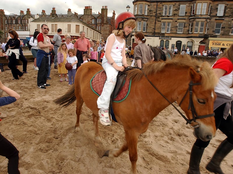 A girl enjoys a donkey ride during the Portobello Golden Days Festival in June 2002.