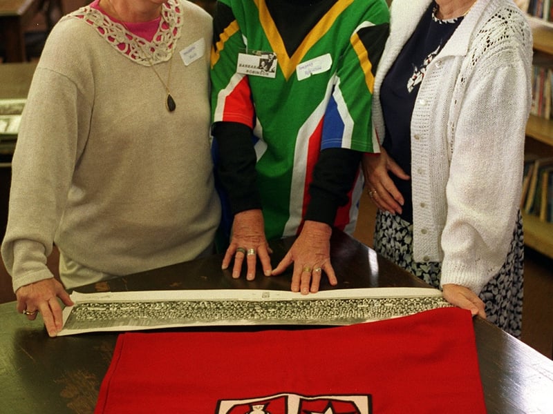 Former pupils at Lawnswood Girls High School came together for a reunion. Pictured are three alumni who were living abroad, looking at an old school photo and the old school banne - , Dr Maureen Rudzik (Canada), Barbara Robinson, (South Africa), and Mavis Webster (New Zealand).