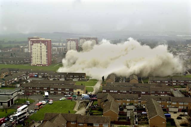 Dust cascades across the Swarcliffe estate from the remains of the two blocks of flats that were demolished in March 2001.