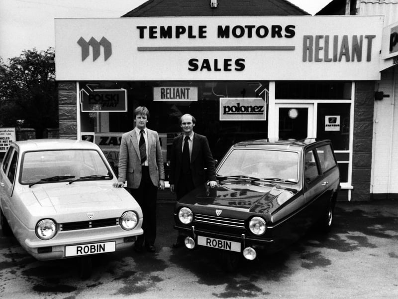 Brian Goldsborough and Alan Jones with two Robin Reliant cars at the Temple Motors showroom, in Leeds, in May 1981
