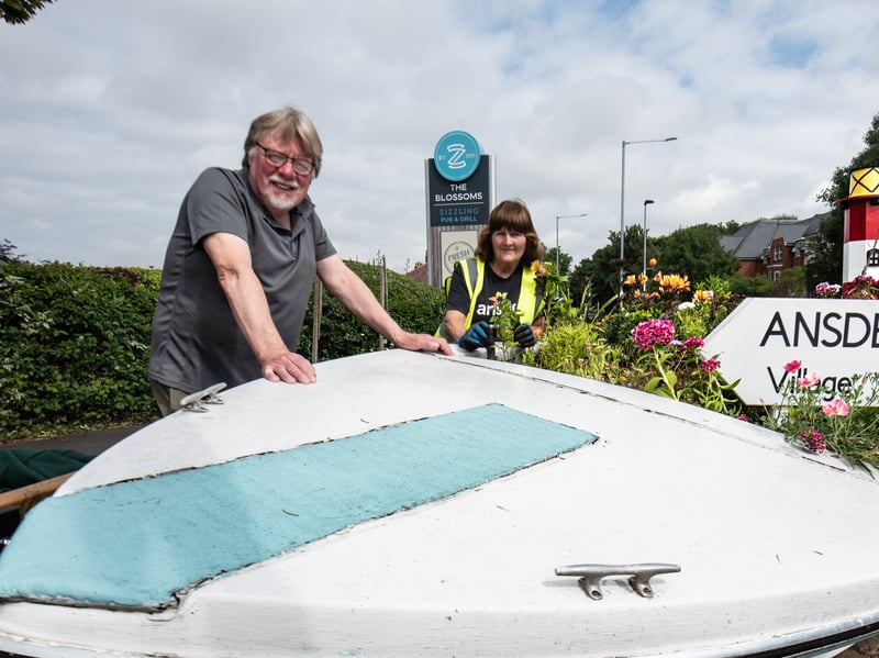 Ansdell In Bloom volunteers - Alan Roe, Pauline Weafer and Gill Thompson with an old speedboat that has been given new life as an eye-catching plantpot outside The Blossoms pub. Photo: Lucinda Herbert