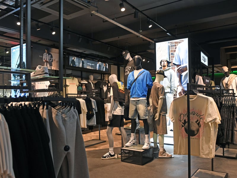 The store uses high-octane architectural lighting and raw concrete aesthetics to match the energetic pulse of Leeds' street culture.
