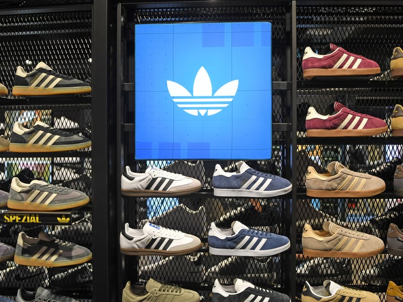 Rows of immaculate, freshly unboxed footwear sit perfectly aligned under the neon glow ahead of tomorrow's launch.
