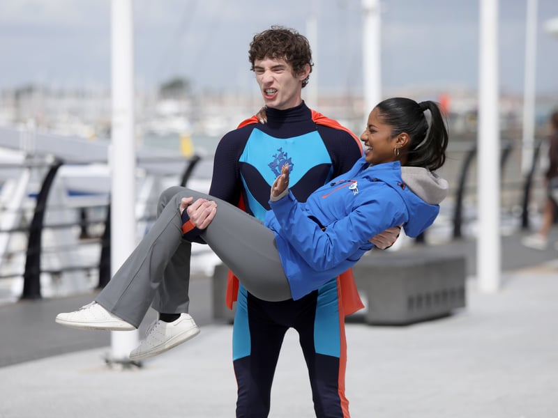 Joel Mawhinney carrying fellow presenter  Shini Muthukrishnan 