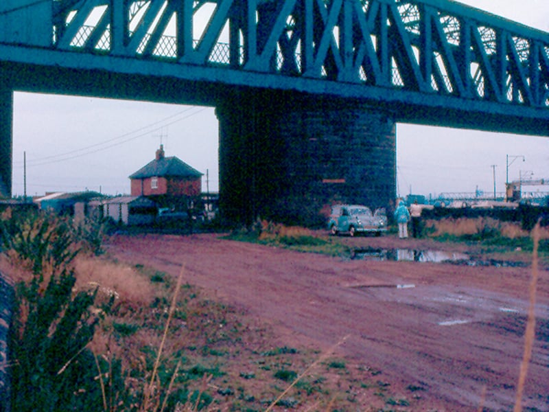 The iron swing bridge which crosses the River Aire at Thwaite Mills. It connected the Hunslet Goods Yard rail line to Stourton Goods Yard. The lock-keeper's house is visible in the background left of centre. The bridge was demolished in 1977 although the circular stone pivet still stands.