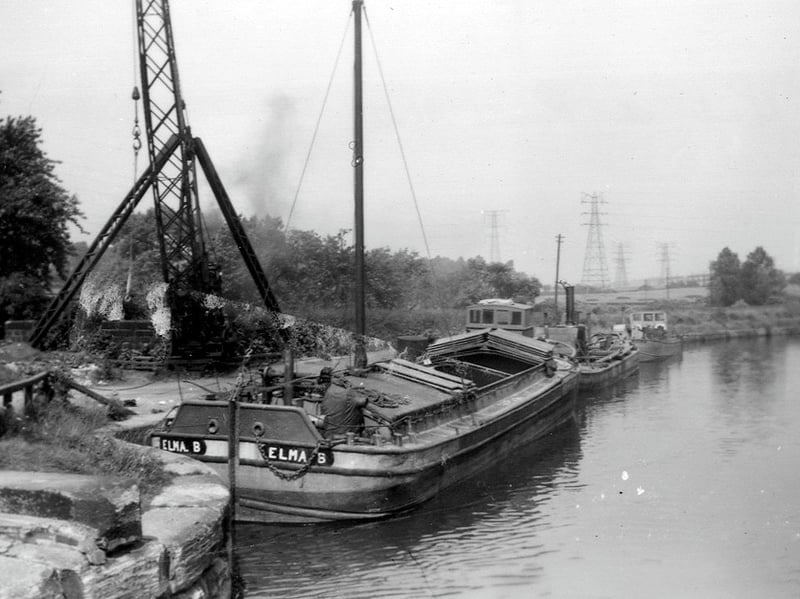 The boat 'Elma B' and others at Thwaite Mills Wharf on the River Aire, looking east. Pictured circa 1950s.