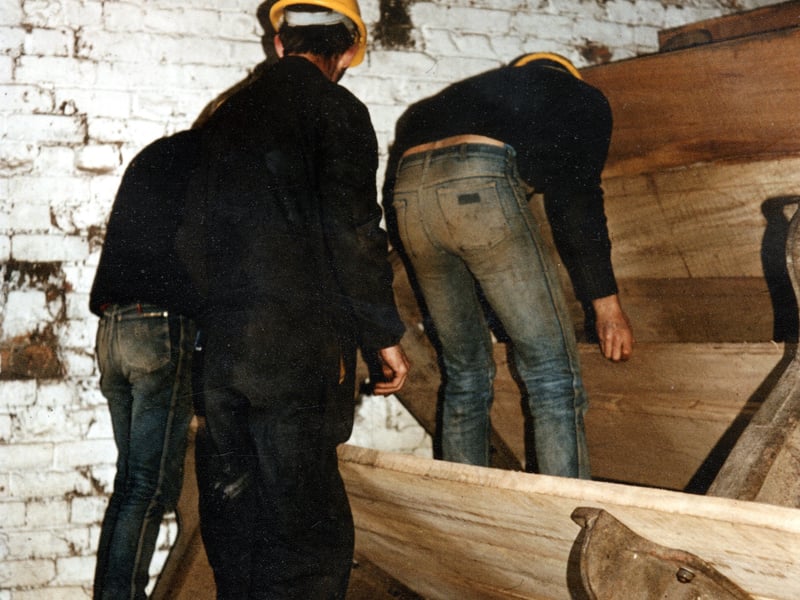 Repairs to the waterwheel circa 1985. Both wheels have a diameter of 5.6 metres, are made of iron with wooden buckets of elm. At this time the mill was being restored by enthusiasts through the Thwaite Mills Society.