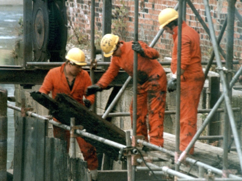 Repairs of river bars on mill race at Thwaite Mills circa 1985. At this time the mill was being restored by volunteers through the Thwaite Mills Society.