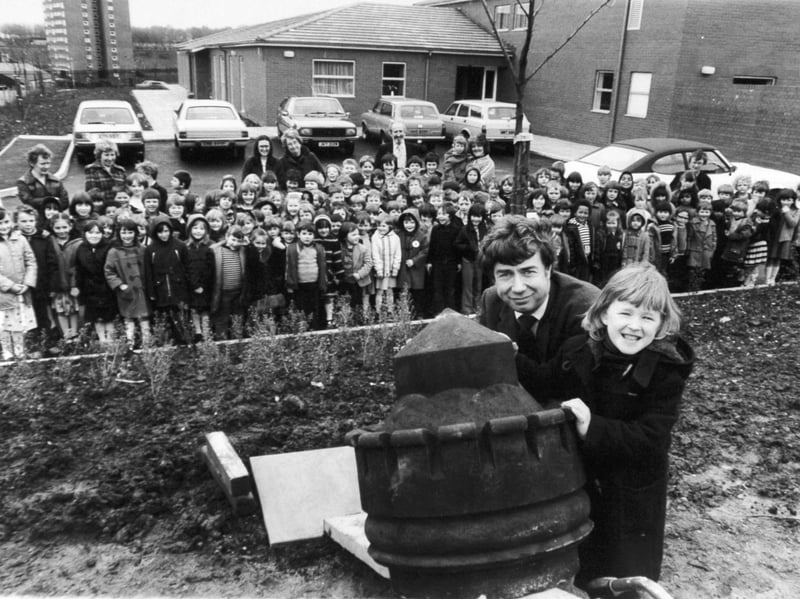 A 100-year-old castle-shaped gatepost top from the old school is planted in the grounds of the new Castle Primary School, in Armley, Leeds,  in March 1981. When it was in its Victorian Armley Road premises, the establishment had been dubbed 'the school for scandal'. Sarah Trigg, aged five, is pictured helping John Creswell, of Witt, Newton and Co stonemasons, install the old stone at its new site, as staff and pupils look on.
