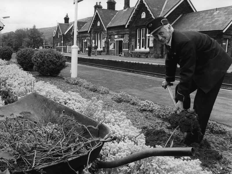 Jim Baker tends to the garden at Settle railway station in May 1981