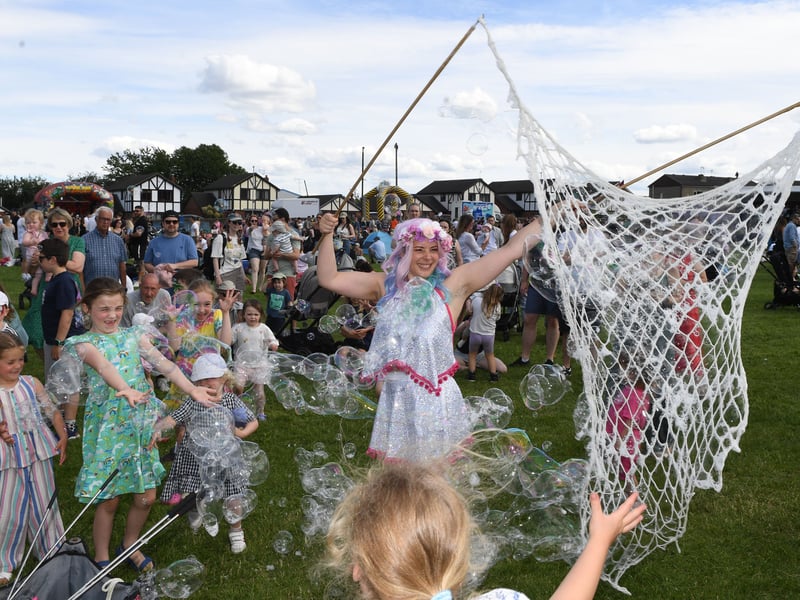 Shelly Skye of Strawberry Circus making bubbles for the children to catch.