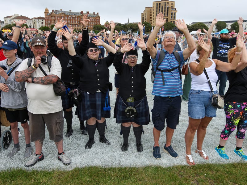 People waving at the drone and satellite.