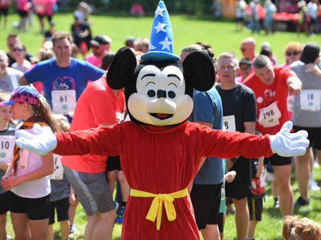 Mickey Mouse joins in the warm up for the race.