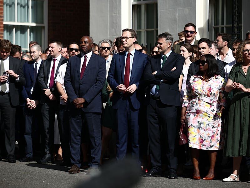 Britain's Justice Secretary and deputy Prime Minister David Lammy (centre left) waits with members of Downing Street staff before Britain's Prime Minister Keir Starmer's resignation address.