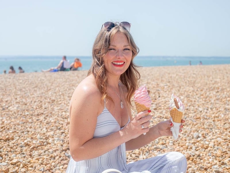 Carrie Nightingale enjoying a couple of ice creams on Southsea beach.