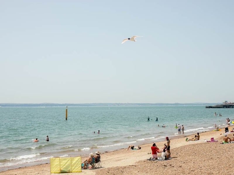 People enjoying the sunshine at Southsea seafront.