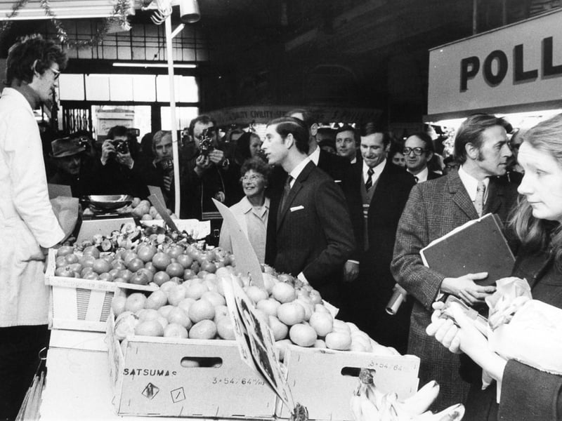 Prince Charles chats to a greengrocer at Kirkgate Market, Leeds, during his walkabout in December 1975