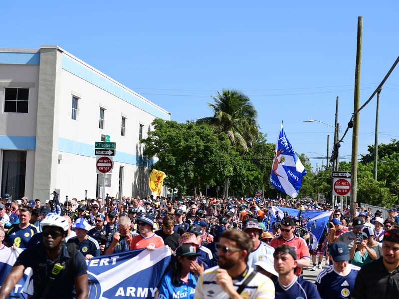The Tartan Army march to LoanDepot Park in Miami. 