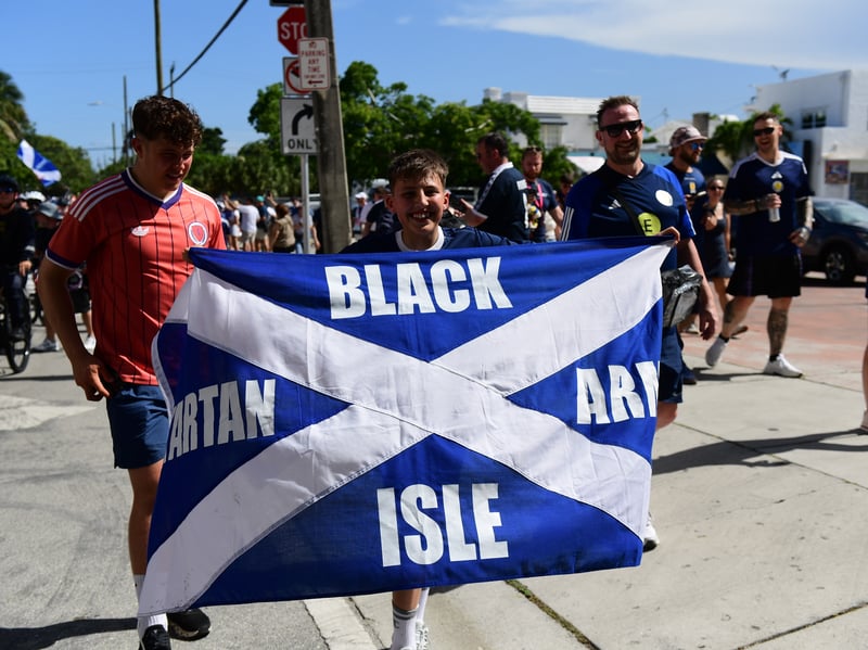 The Tartan Army march to LoanDepot Park in Miami. 