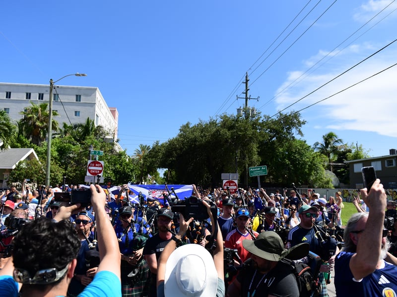 The Tartan Army march to LoanDepot Park in Miami. 
