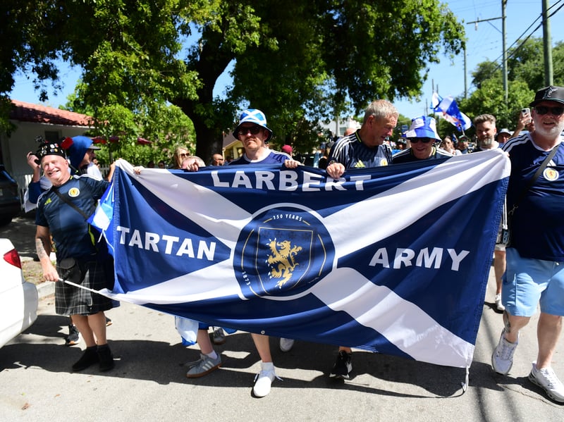 The Tartan Army march to LoanDepot Park in Miami. 