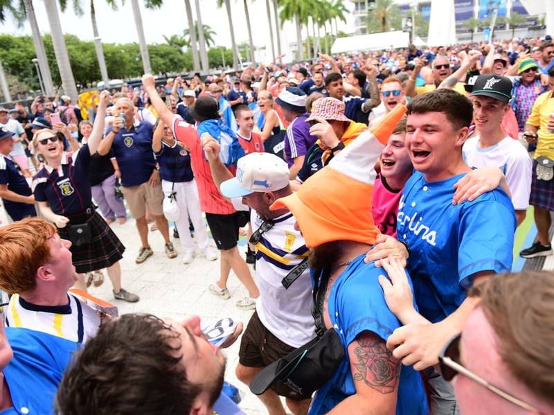 The Tartan Army march to LoanDepot Park in Miami.