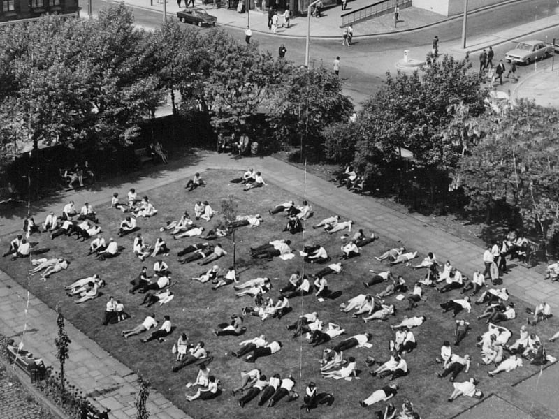 A photo taken from the tower of St. John's Church showing office workers taking in the sun during their lunch break in June 1981.