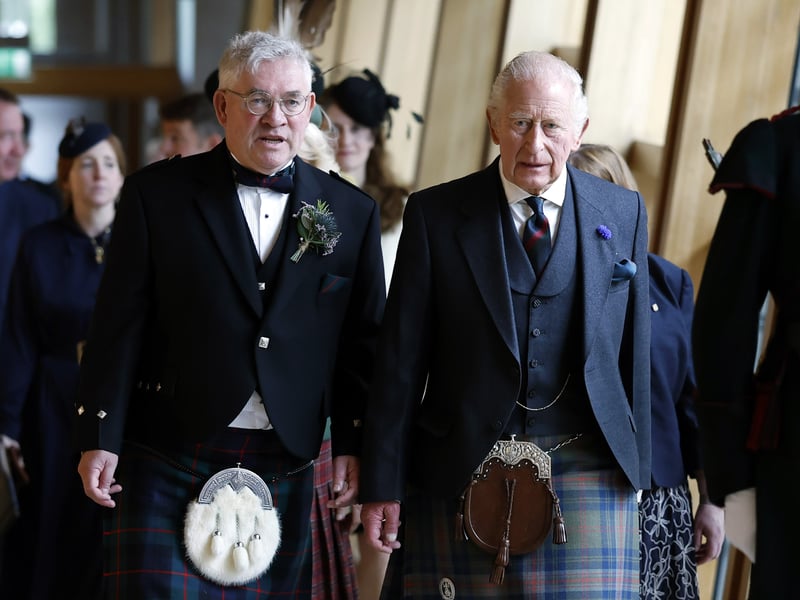 King Charles III is escorted by the Presiding Officer Kenneth Gibson MSP, followed by Queen Camilla, as they arrive for the opening of the seventh session of the Scottish Parliament in Edinburgh.