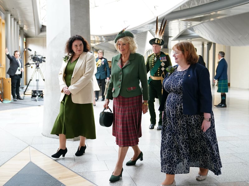 Queen Camilla arrives with Deputy Presiding Officers Katy Clark (left) and Clare Adamson (right) for the opening of the seventh session of the Scottish Parliament in Edinburgh.