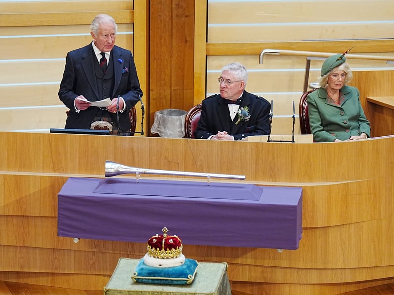 King Charles III delivers a speech as Presiding Officer Kenneth Gibson (centre) and Queen Camilla look on during the opening of the seventh session of the Scottish Parliament in Edinburgh.