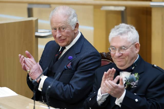 King Charles III applauds with Presiding Officer Kenneth Gibson MSP in the Debating Chamber during the opening of the seventh session of the Scottish Parliament in Edinburgh
