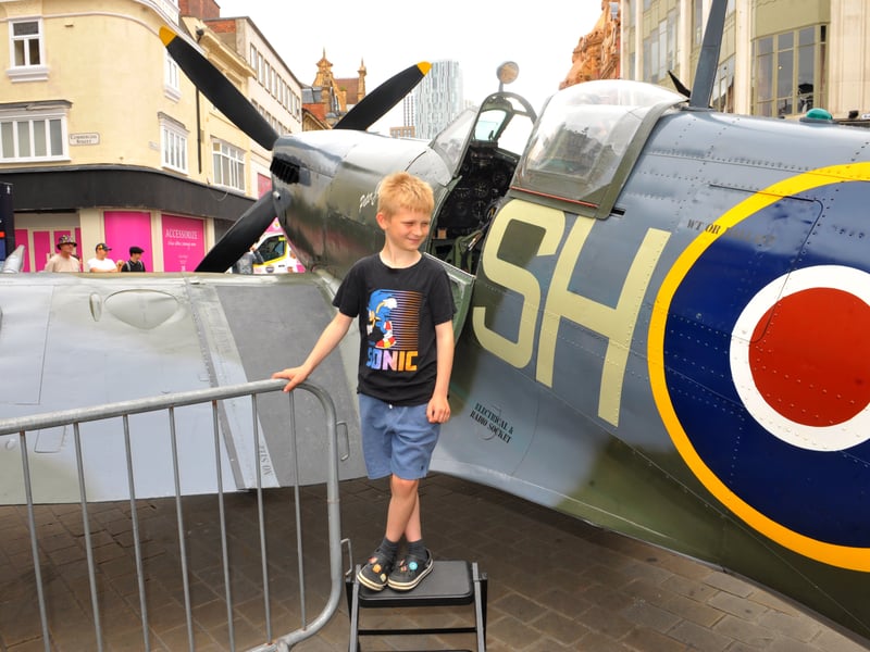 Jake Needham, eight, of Leeds has a look round the famed Spitfire plane on Briggate.