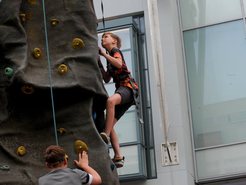 Ryan Etheve, 11, of Leeds makes progress on the towering climbing wall.